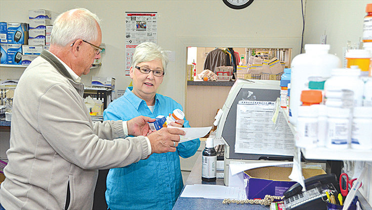 Lynn Glasser, left, and Patricia Dowdy work on a prescription Monday at Chatham Cares Pharmacy, located on Raleigh Street in Siler City