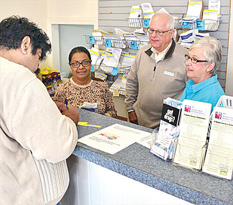 Pharmacy manager Lynn Glasser, second from the right, and staff help a customer.