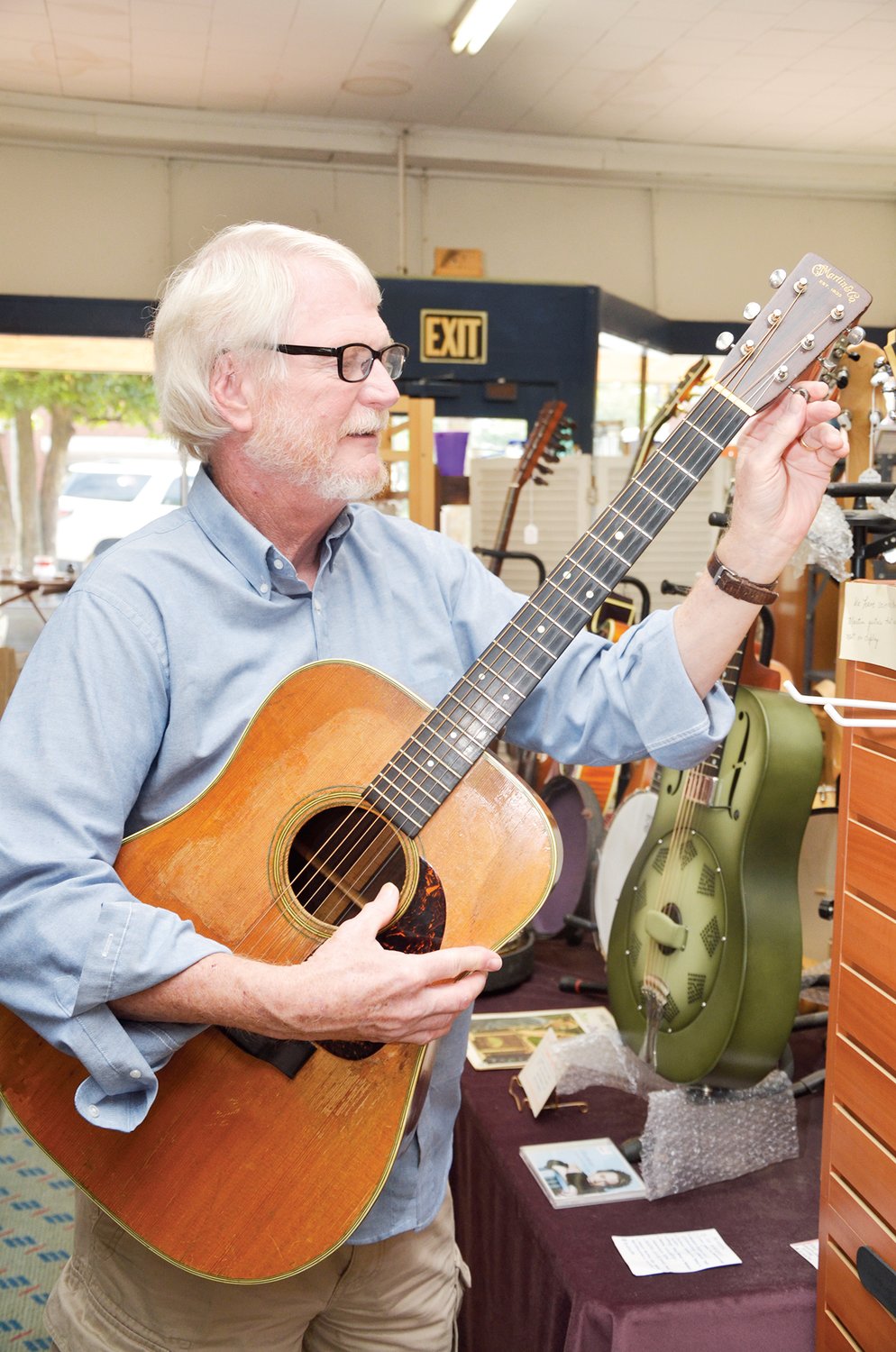 One of Tommy Edwards’ favorite instruments in his store on Hillsboro Street in Pittsboro is this classic 1950 Martin D-28. Other offerings in the store include a National Steel Resonator guitar, and other non-musical items such as silver, electric lamps from the 1930’s, and other decorative items.