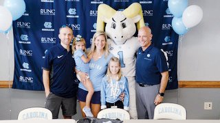 Kelsie Houston of Pittsboro signs with the University of North Carolina women's volleyball program in Carmichael Arena in Chapel Hill on Saturday. Pictured (from left) are father Nathan, sister Mackenzie, mother Kimberly, Kelsie, UNC mascot Ramses and UNC volleyball coach Joe Sagula.