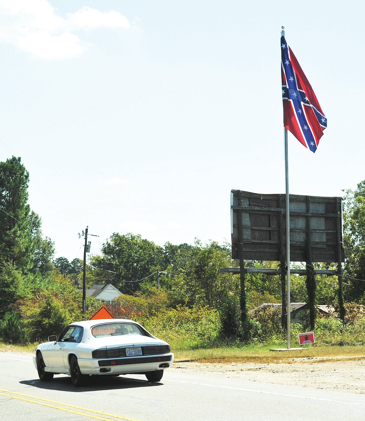 A recently-erected Confederate Battle Flag flies above Highway 64 near Pittsboro.