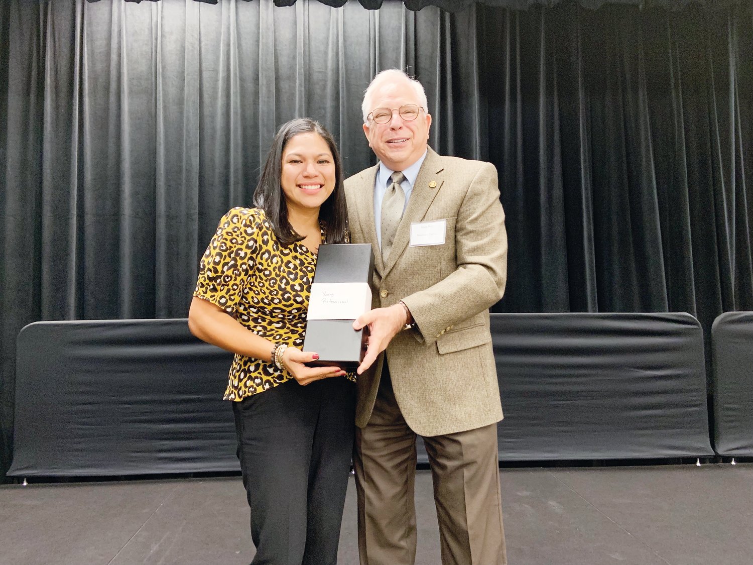 Jennifer Gordiano, left, realtor with Chatham Homes Realty, receives the award for Young Professional of the Year, presented by Mark Reif, North Carolina community relations manager of Mountaire Farms, at the Chatham Chamber of Commerce’s Annual Meeting last week in Pittsboro.