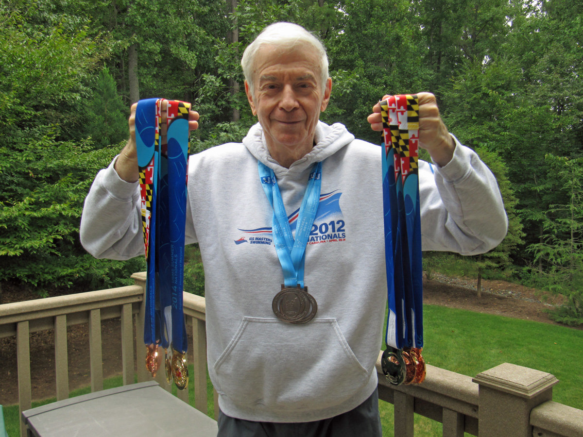 Steve Barrett, 86, of Pittsboro, has participated in the Chatham County Senior Games since 2008. In this photo, he poses with some of the national medals he's also won.