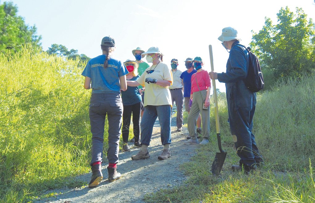Gretchen Smith (middle), the president of the Friends of the Lower Haw River State Natural Area, identifies plants to be removed.