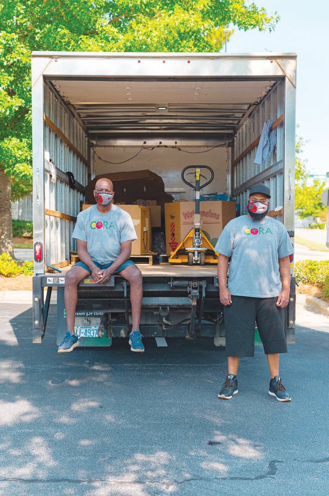 Reggie Blue (left) and Travis Viera pose for a shot with the CORA donation truck.