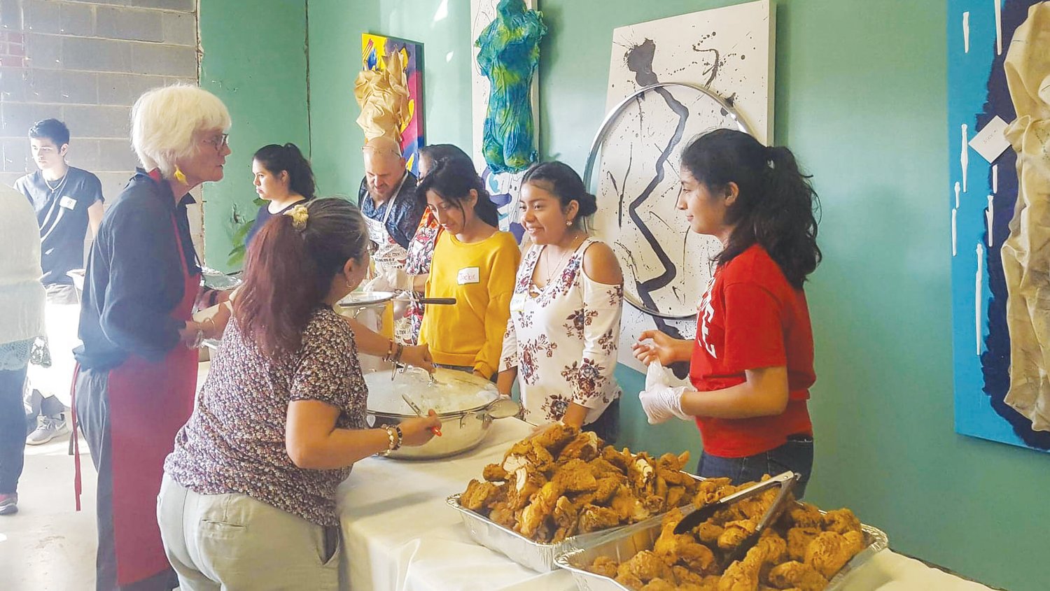 Members of the Hispanic Liaison’s youth group, Orgullo Latinx Pride, help out during the community dinner held annually at Peppercorn in the fall.
