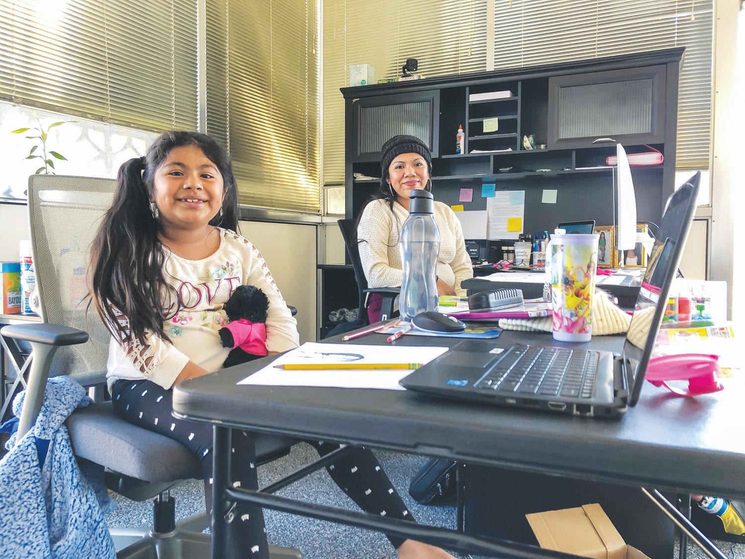 Jessica Hernández Guerrero, 29, brings her daughter to work with her every day in Siler City, where she works as an accountant for Warrior Steel Erection Corporation. Her daughter Hailey, a 2nd grader at Green Ridge Elementary in Biscoe, said she liked online school 'because you can turn off the camera and go to sleep.'
