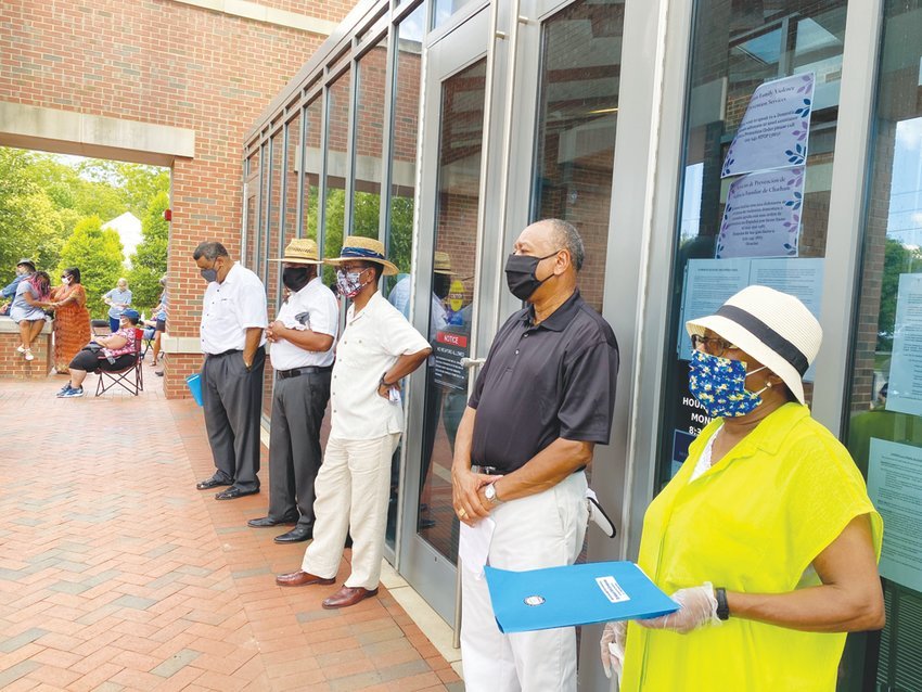 Chatham Community (East) Branch of the NAACP President Mary Nettles (right) and West Chatham NAACP President Larry Brooks (2nd to right) at an event calling for justice last July, sponsored by the nonprofit organization Community Remembrance Coalition Chatham.