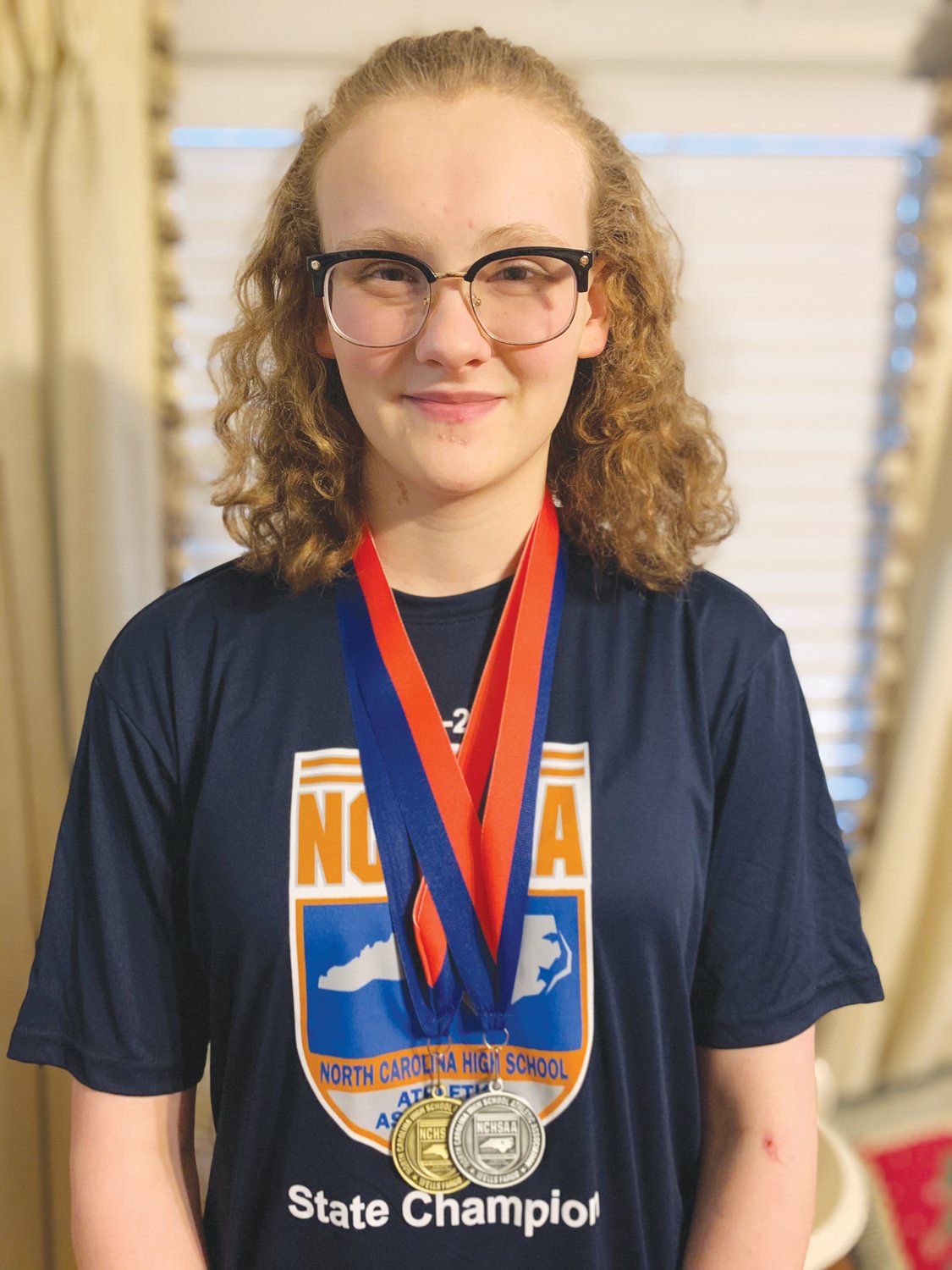 Jordan-Matthews' Jennah Fadely poses with the two medals she won at the NCHSAA 1A/2A Swimming State Championships on Friday in Cary. Fadely would take the state title with a record-setting time of 1:02.11 in the women's 100 breaststroke.