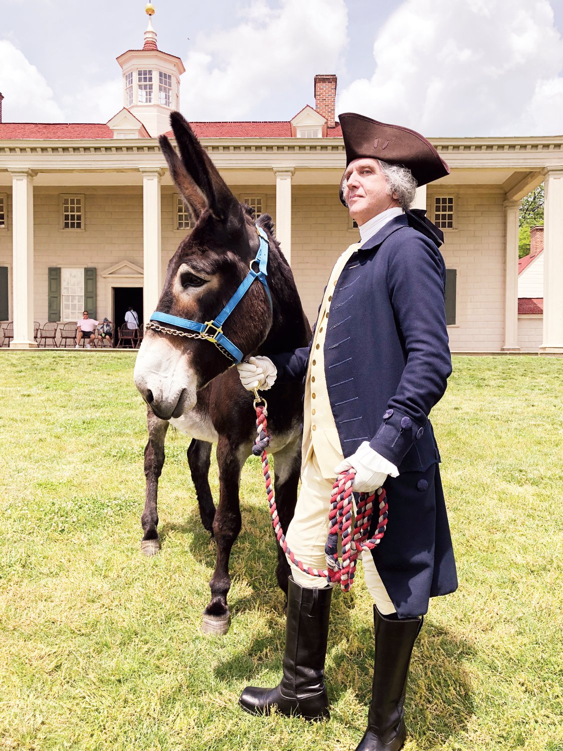 Actor Daniel Shippey portrays President George Washington at the stamp ceremony at Mount Vernon. Washington signed legislation that created the USPS and was known for his advocacy of mules.