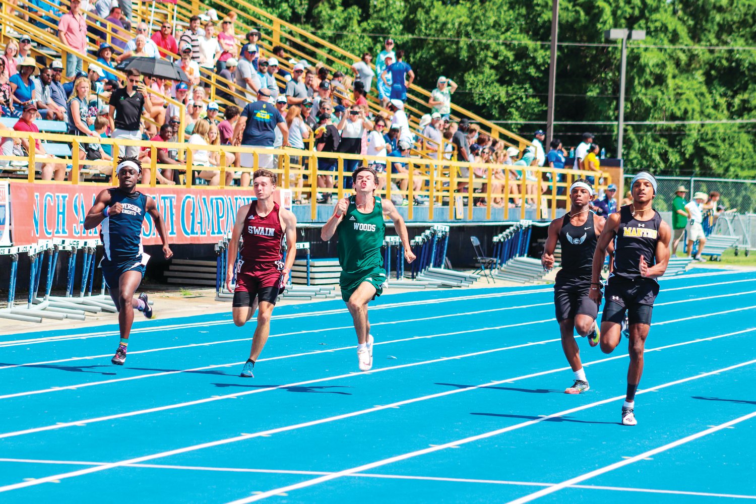 Woods Charter senior Kyle Howarth (green) strides down the track in the boys 100-meter dash at the 1A NCHSAA Track & Field State Championships at North Carolina A&T State University in Greensboro last Friday. Howarth placed 6th in the event (11.64) and 9th in the boys 200-meter dash (23.96).