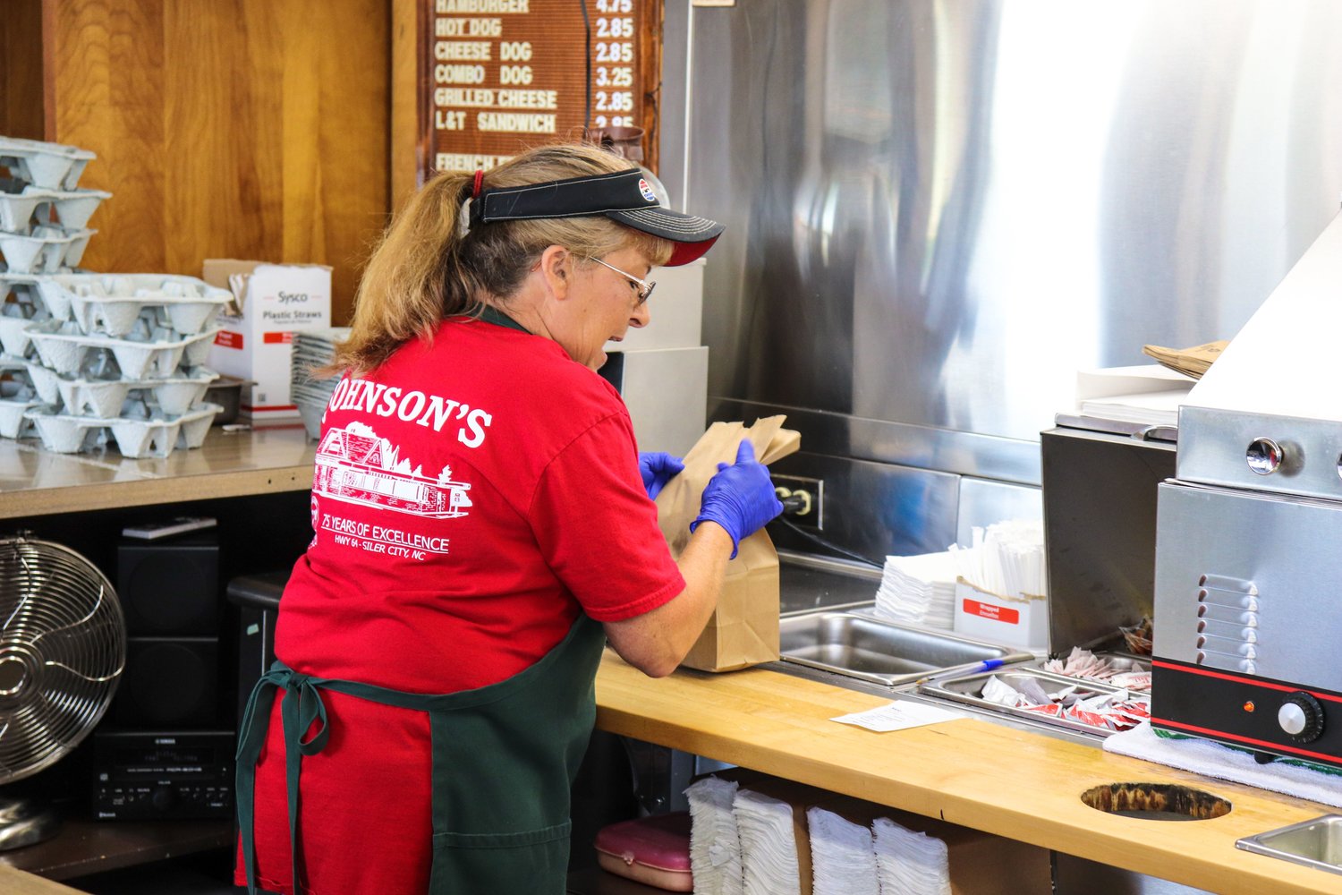 Anita Hammer prepares a food order this past Friday at Johnson’s restaurant. She’s been working at Johnson’s for 14 years.