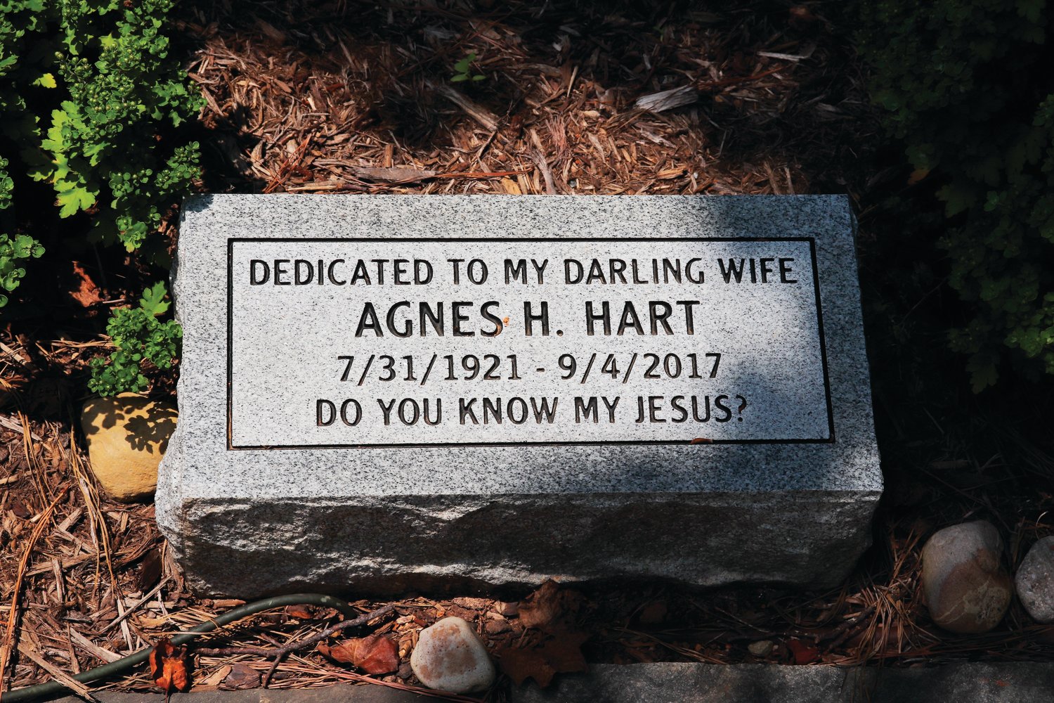 A stone Wesley Hart had made for his late wife, who died a month before the couple's 75th anniversary. The quote on the marker — 'Do you know my Jesus?' — is something Agnes Hart would ask everyone who visited their home. The marker is part of a memorial Hart erected at his home.