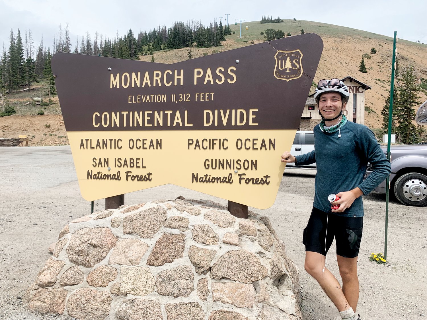 Emmaus Holder poses in front of the sign at Monarch Pass in Chaffee/Gunnison counties in Colorado during his 56-day cross-country cycling trip this summer.