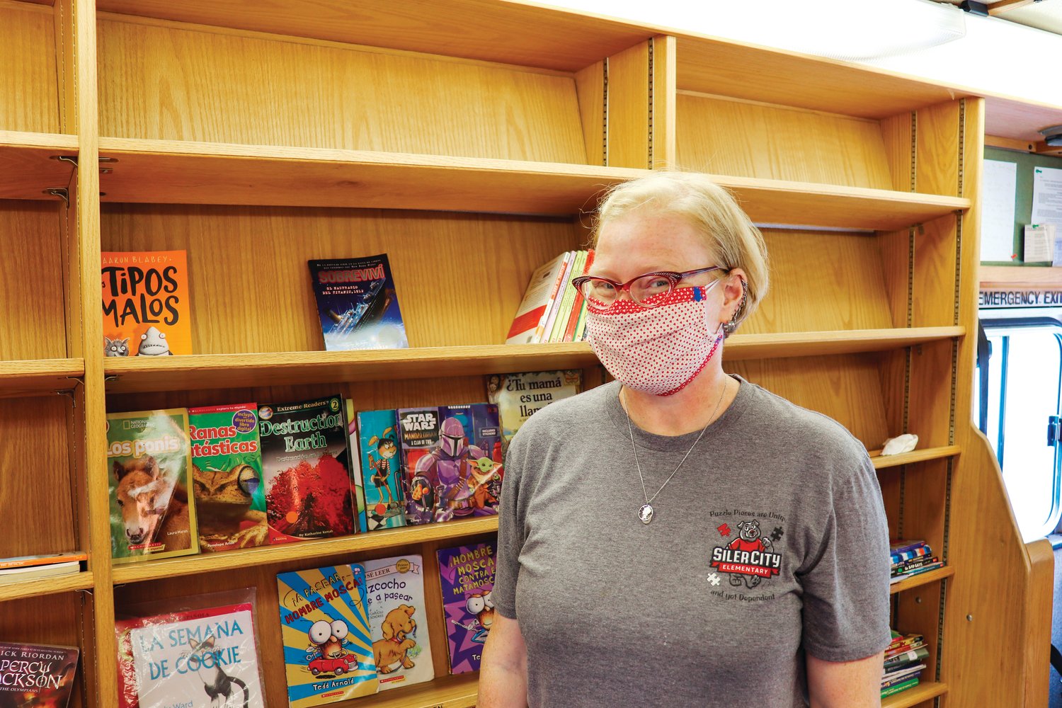 Beth Kalb, a media specialist with Siler City Elementary School, stands inside the Bookmobile this past Tuesday during one of the bus stops. She's been running SCE's Bookmobile for about four years.