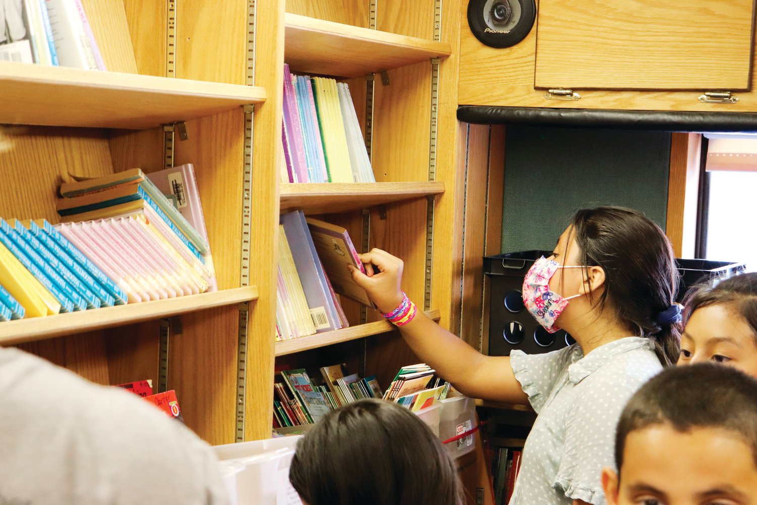 Melani Canela Soto picks out her last book inside the Bookmobile last Tuesday at Virginia Cross Elementary School. VCE was one of five stops that the Siler City Elementary Bookmobile visited.