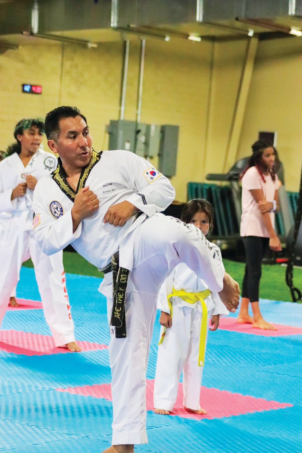 A.F.E. Taekwondo Fitness Academy owner, founder and master instructor Antonio Ara (front) practices his kicking form during the beginner's class on Monday. Ara has been practicing taekwondo for nearly 40 years.