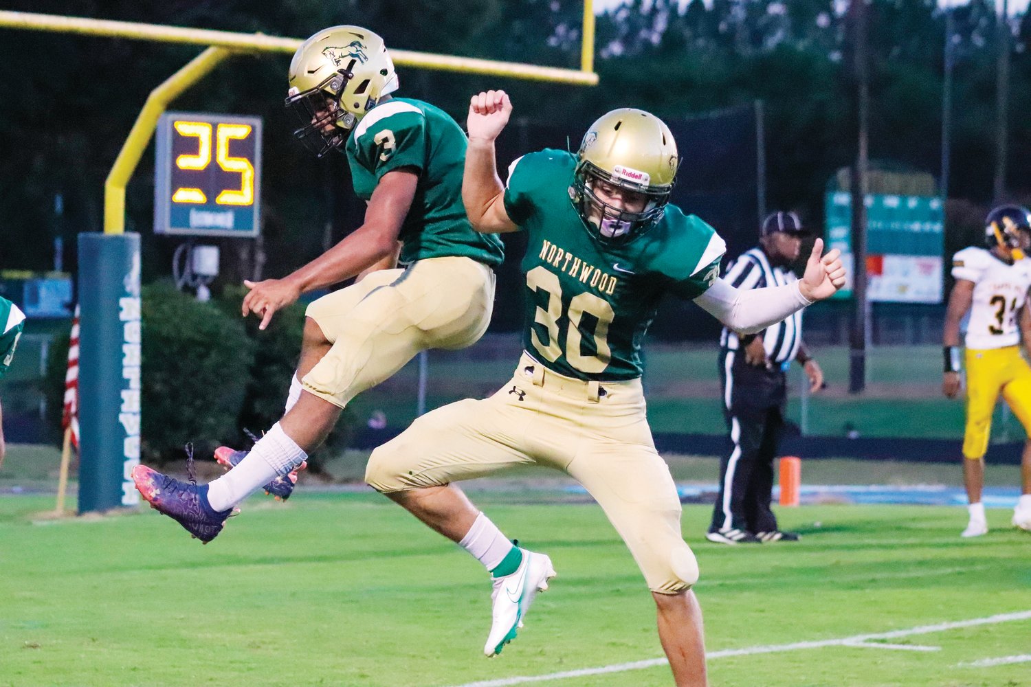 Northwood seniors Jalen Paige (3) and Braden Meacham (30) celebrate after Paige scores one of his two touchdowns on the night during the Chargers' 36-29 loss to Chapel Hill in Pittsboro on Friday night. Paige was one of two Chargers with a rushing touchdown against the Tigers.
