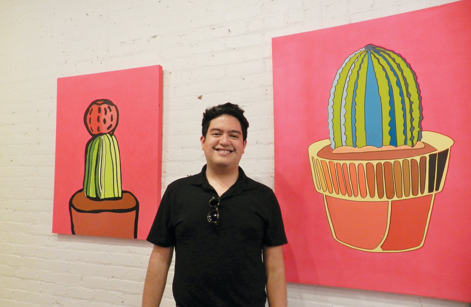 Mexican-American artist Antonio Alanís inside the N.C. Arts Incubator last Friday night with his 'Latinx Visual Resiliency' series, which the gallery displayed in honor of Hispanic Heritage Month.