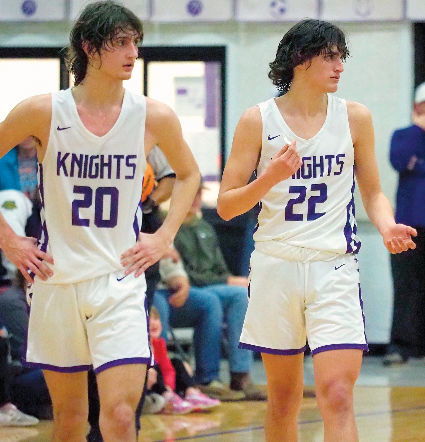 Chatham Charter junior Adam Harvey (20) and freshman Beau Harvey (22) walk down the floor after a whistle in the Knights' 61-35 win over the Bears in Siler City last Friday.