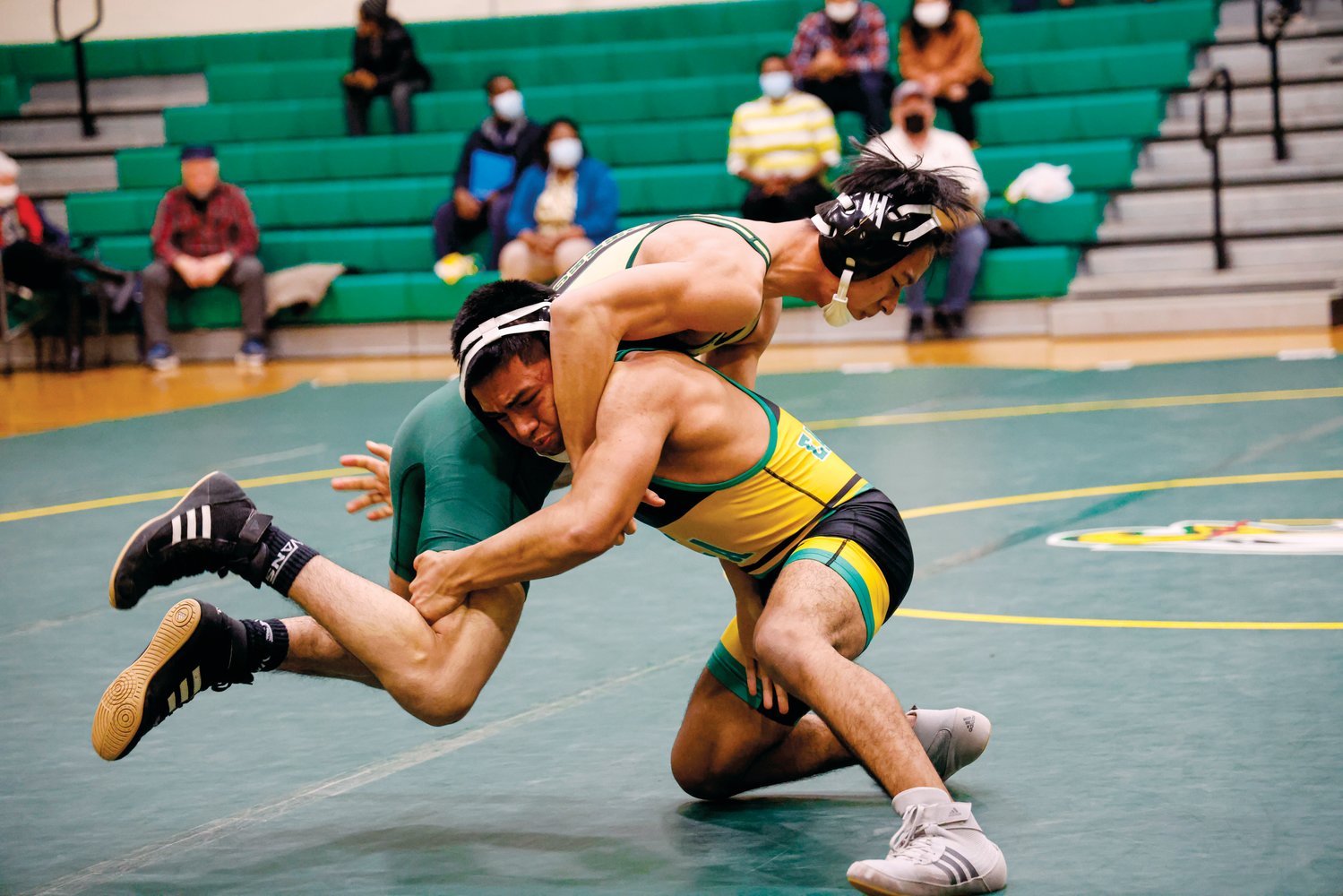 Northwood's Sunday Oo (green bottoms) sprawls and slips in an undertook in an attempt to block a deep double-leg takedown shot by Eastern Alamance 113-pounder Willfen Lopez during the Chargers' 42-36 win over Eastern Alamance last Thursday.