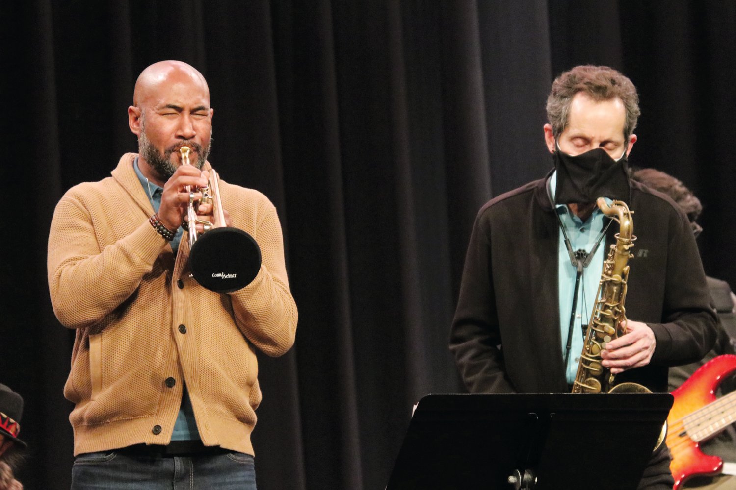 Trumpet player Al Strong (left) and saxophonist Gregg Gelb of La Fiesta Latin Jazz Sextet perform during a Latin jazz workshop they led for student musicians on Jan. 28 in Jordan-Matthews High School. Participating students included the JM Jazz Ensemble and several 8th grade musicians from Chatham Middle and Silk Hope..