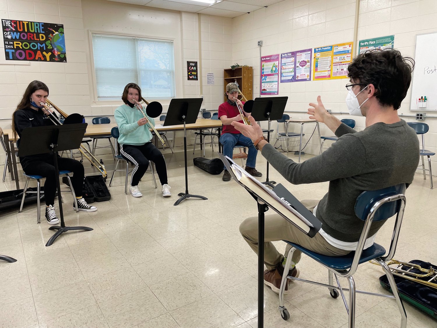 Trombonist and bassist Andy Kleindienst of La Fiesta Latin Jazz Sextet leads Maggie Thornton, Emma Wieber and Gavin Campbell in a Latin jazz session for student trombonists at Jordan-Matthews on Jan. 28.