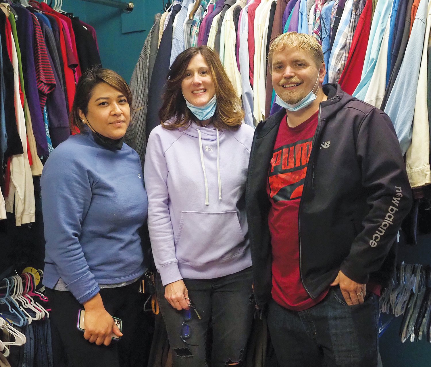 Volunteers Norma Hernandez (left), clothing closet manager Angie Stanley (middle) and Peter Yoho help distribute free clothes to those in need at Freedom Family Church on Feb. 19.