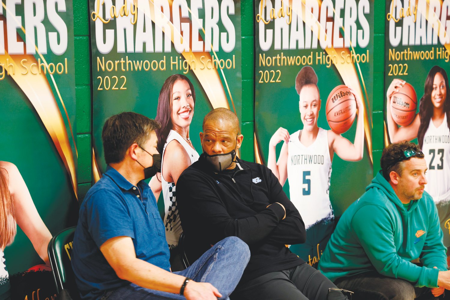 UNC Tar Heels head men's basketball coach Hubert Davis (in black) chats during halftime of the Northwood men's basketball game last Thursday, where he was likely in attendance to watch Chargers sophomore Drake Powell. The Chargers defeated the West Brunswick Trojans in the 2nd round of the NCHSAA 3A playoffs, 80-40.