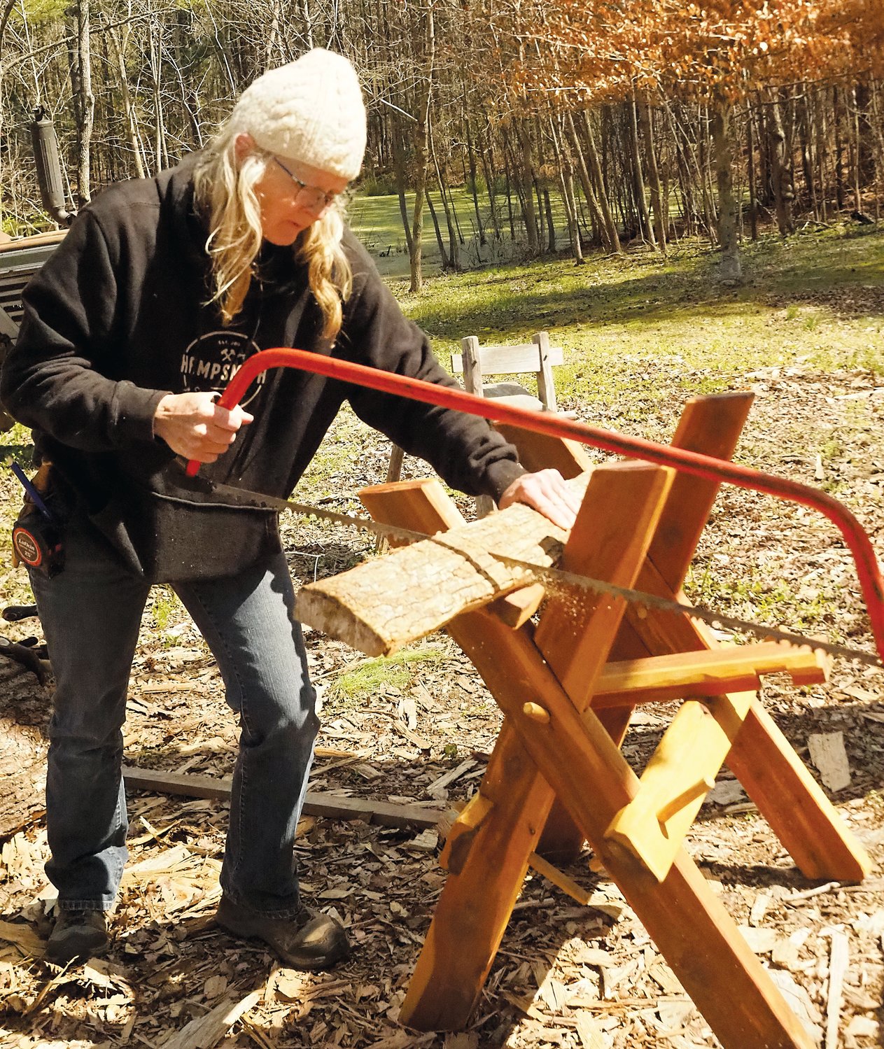 Festival organizer Cara O'Connell shown practicing the art of woodworking.