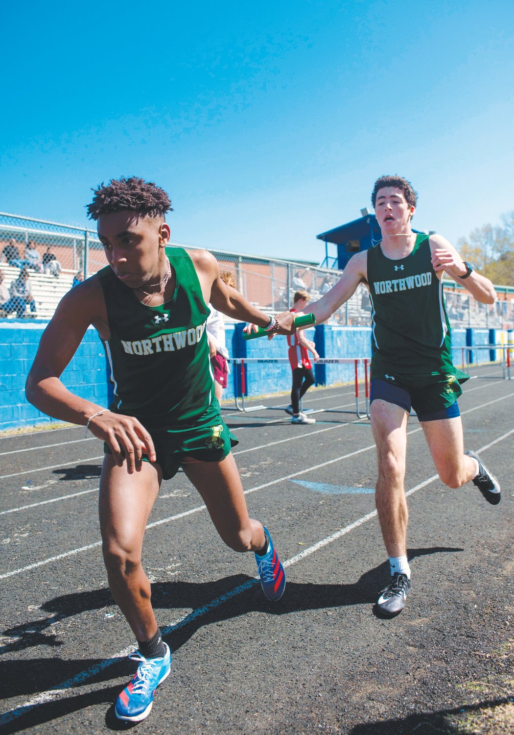 Northwood sophomore Noah Nielson (back) passes the baton to junior Christian Glick during a relay event at the Chatham County Invitational on Saturday.