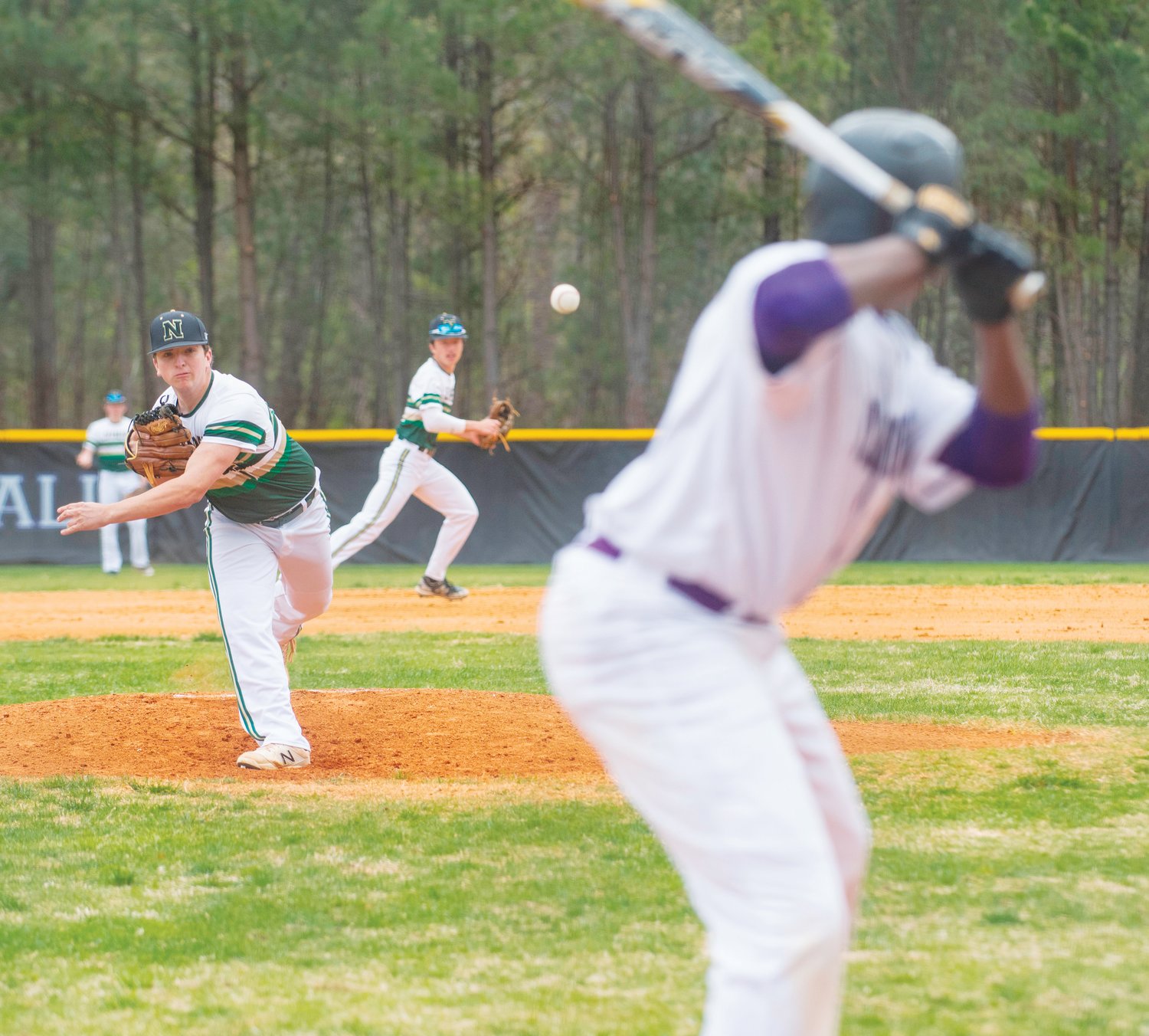Northwood junior Nathan McWilliams (left) throws a pitch to Carrboro sophomore Aric Stewart in the Chargers' 7-3 win over the Jaguars last Saturday. McWilliams threw five innings, allowing six hits and just one earned run in his first start of the season.