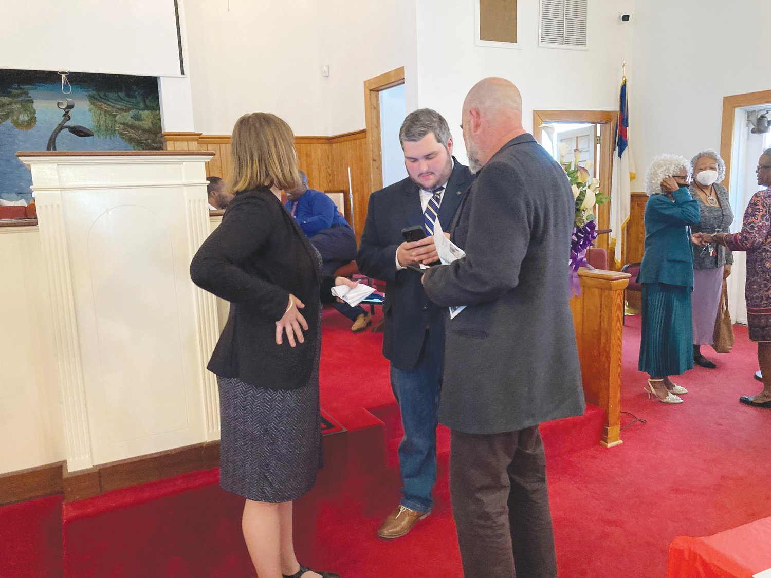Dean Picot II (center) talking to Katie Kenlan (left) after the candidate forum on Sunday afternoon in Siler City.