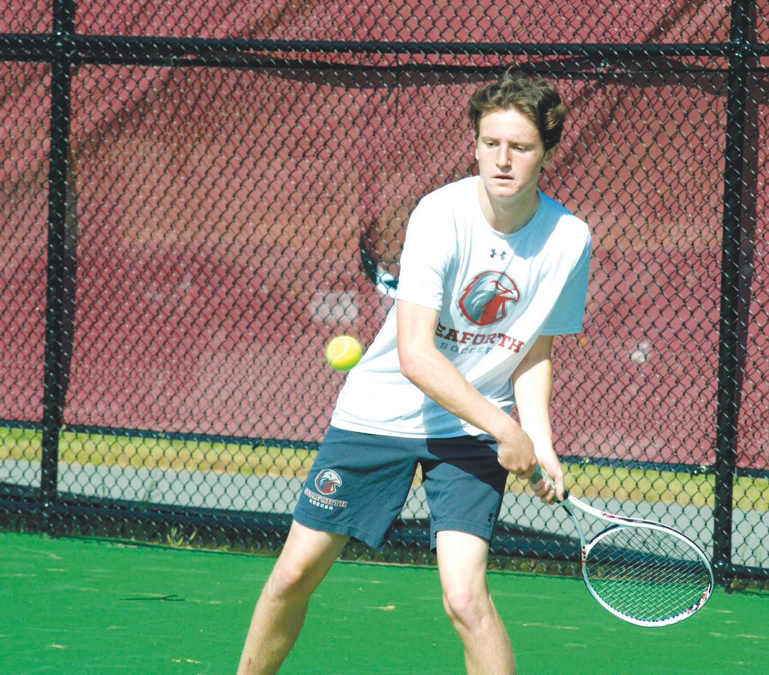 Seaforth sophomore Walker Magrinat returns a volley in his singles match against Raleigh Charter junior Ryan Hill on April 27. The Hawks – including Magrinat, who lost to Hill, 2-6, 1-6 — never left the nest in their battle with Raleigh Charter, losing 8-1 in the first round of the NCHSAA 2A dual-team playoffs.