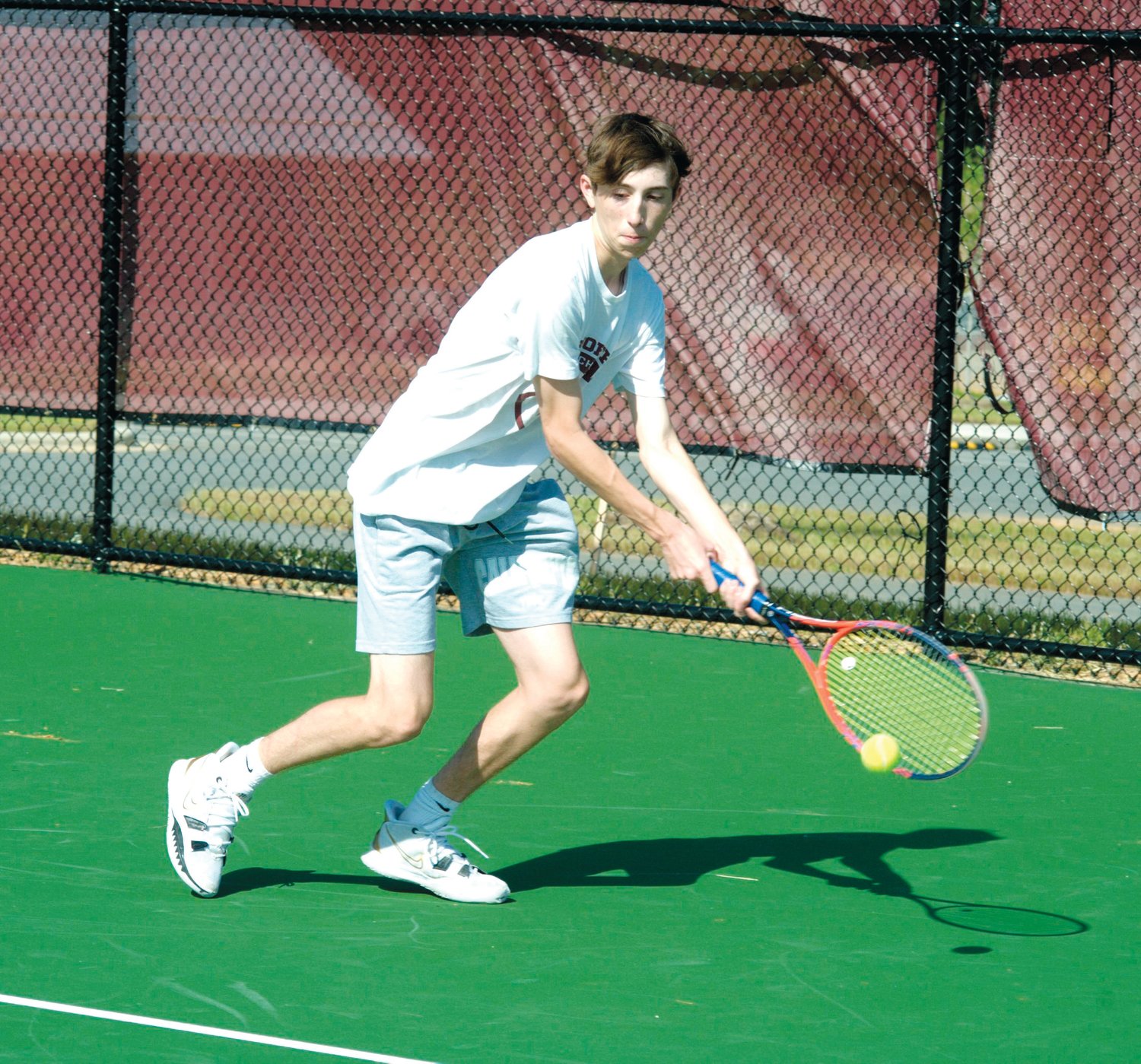 Seaforth sophomore Logan Ching backhands a lob over the net from his singles opponent from Raleigh Charter, sophomore Marshall McClure, who he lost to (1-6, 2-6), in the Hawks' first-round upset to the Phoenix, 8-1. Despite the loss, Seaforth Head Coach PJ Petrides gave Ching the metaphorical game ball for the match.