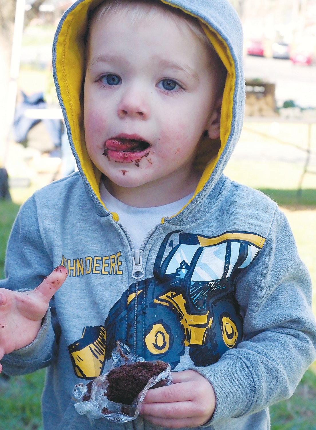 Archer Priestley, 3, of Pittsboro, samples a fresh brownie at the Chatham Mills farmers market.