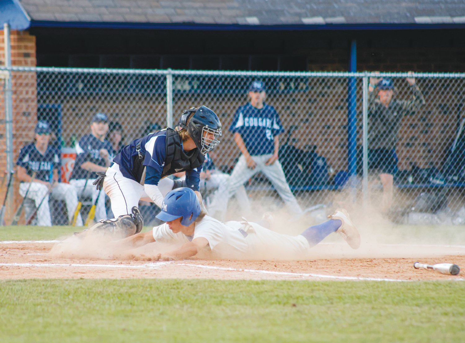 Jordan-Matthews [identify baserunner] (in white) slides across home plate in the Jets' 3-1 first-round win over the Southwest Edgecombe Cougars on May 10.