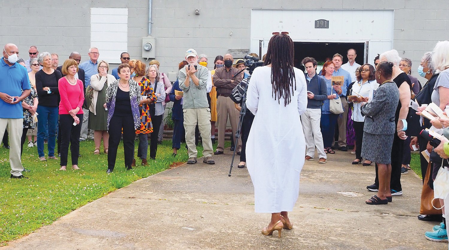 Karen Howard leads the libation ceremony at Saturday's remembrance event.