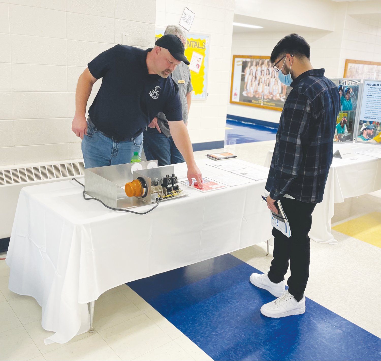 Siler City resident José Lopez, 26, visits a table at Central Carolina Community College's community career night at Jordan-Matthews High School. Lopez hopes to educate Latino community members about employment opportunities.