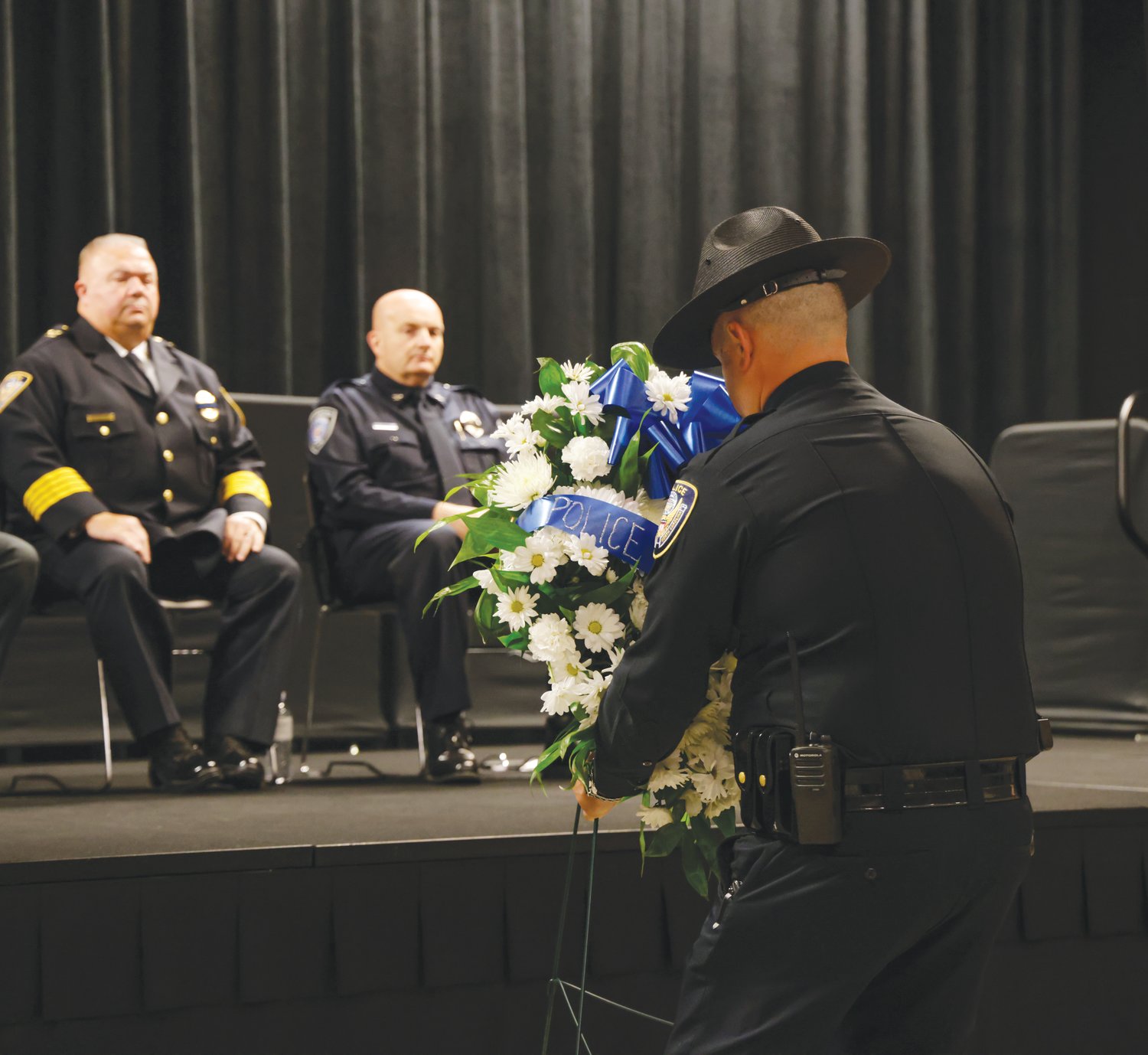 A police officer places this year's Police Remembrance Week wreath during the county's observance last Wednesday.