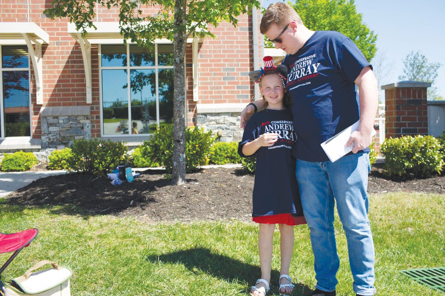 Derek Murray campaigns for his father, District Attorney Andrew Murray with his daughter Charlotte on May 17 in Henderson County at the Fletcher Town Hall polling place.
