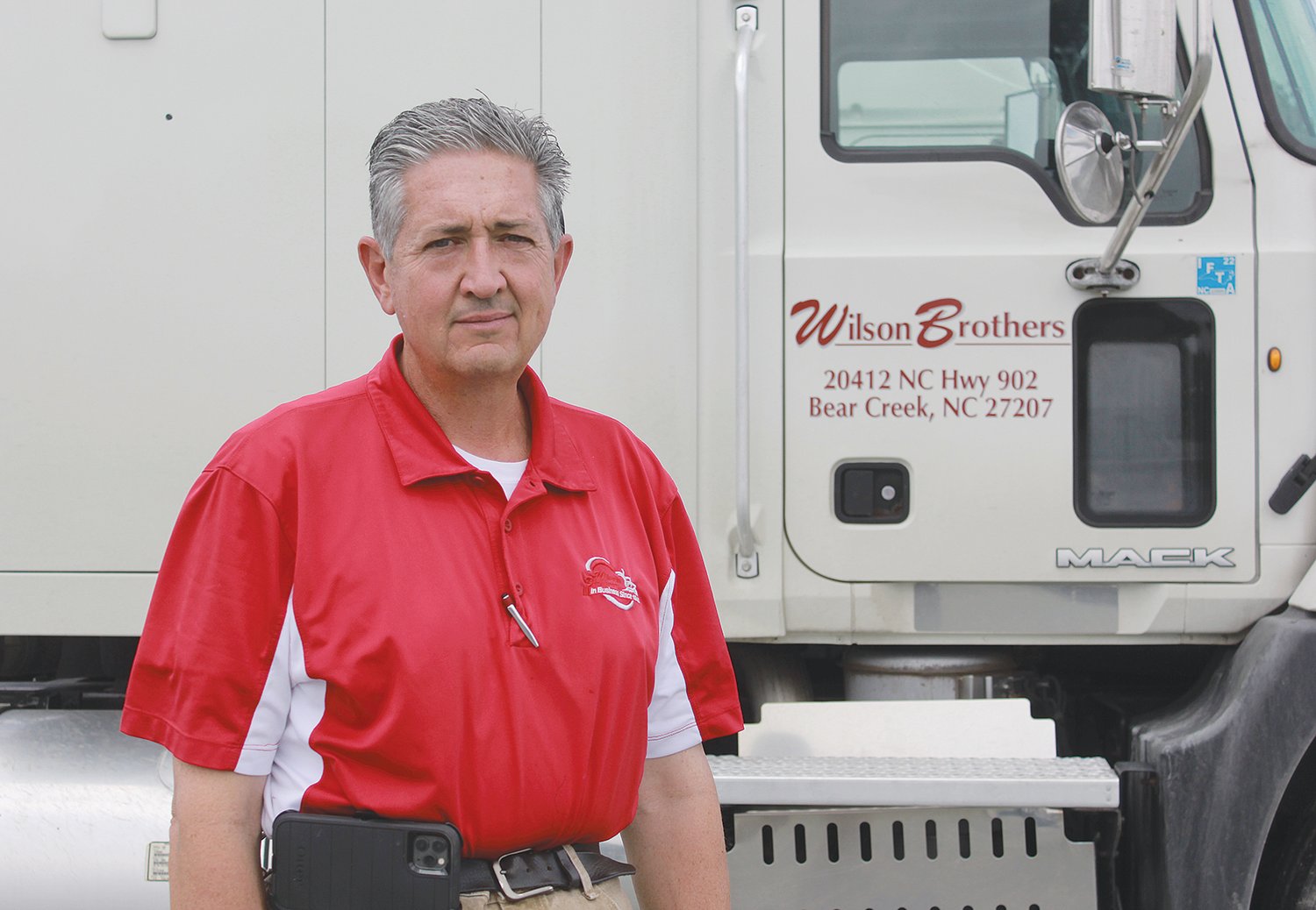 Jeff Wilson, president of Wilson Brothers Milling and Trucking Co., stands next to one of his company's trucks on Friday. Wilson Brothers drivers put more than 4 million miles on those trucks annually, so increases in fuel prices are something Wilson pays attention to.