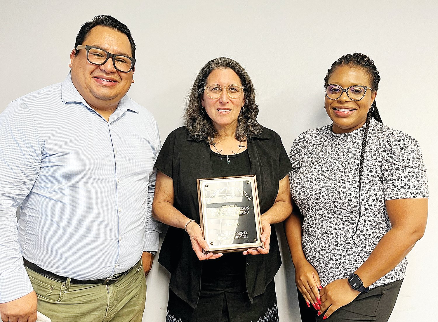 COVID-19 Project Manager Will Mendoza, left, and Executive Director Ilana Dubester, center, received the 2021-22 Community Partner of the Year Award from the Chatham County Board of Health on May 23. The award was presented by Board of Health Chairperson Dr. Karen Barbee, right.