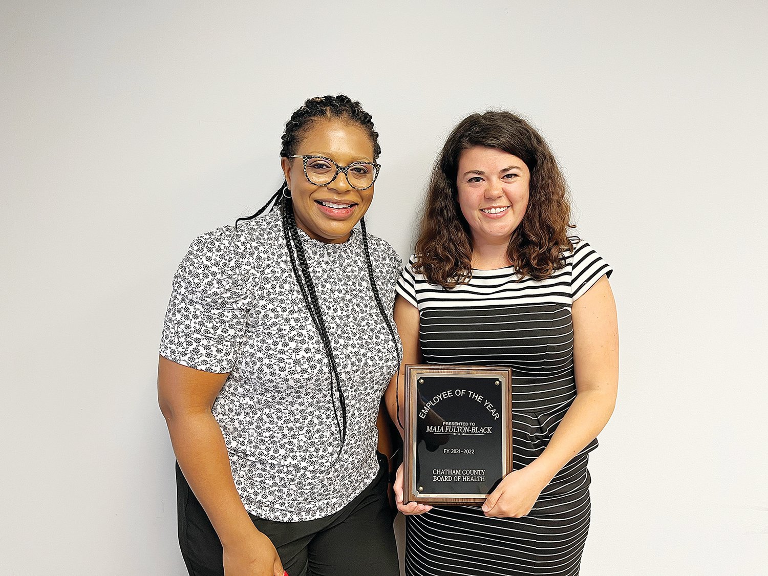 Maia Fulton-Black, right, receives the 2021-22 Chatham County Board of Health Employee of the Year award from Dr. Karen Barbee, chairperson of the Chatham County Board of Health, last Monday in Pittsboro.