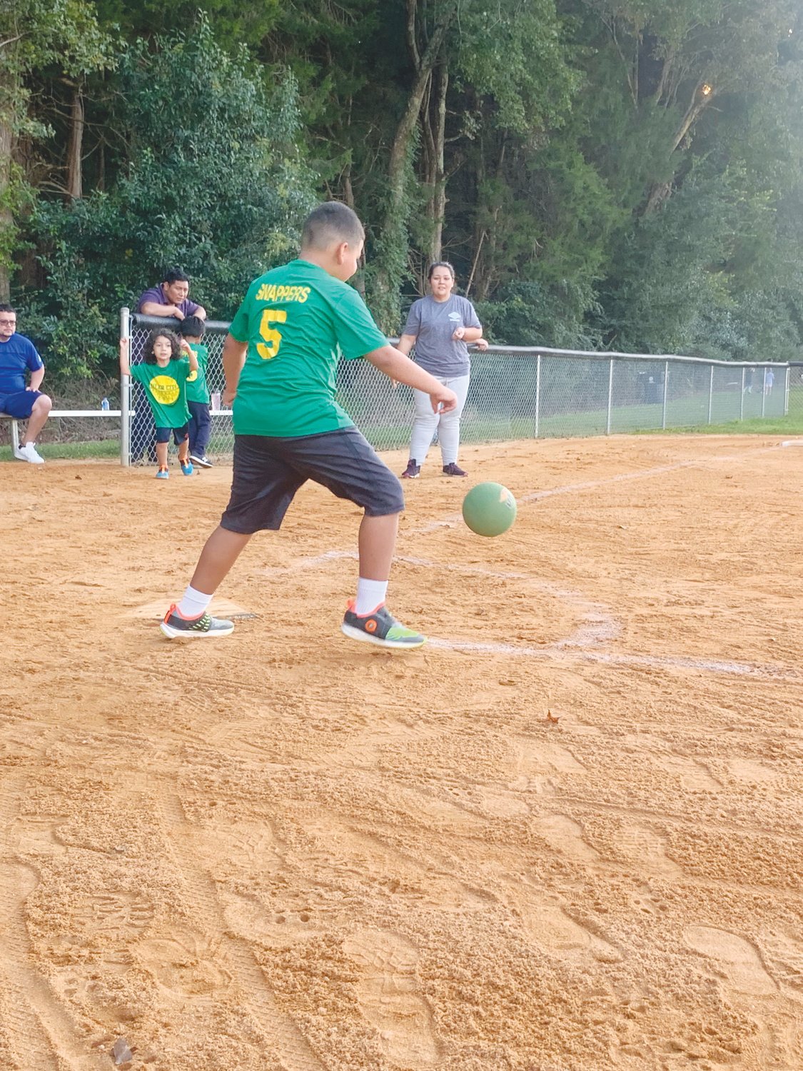 A local athlete takes his shot at getting a hit in Siler City Parks and Rec's youth kickball league last September.
