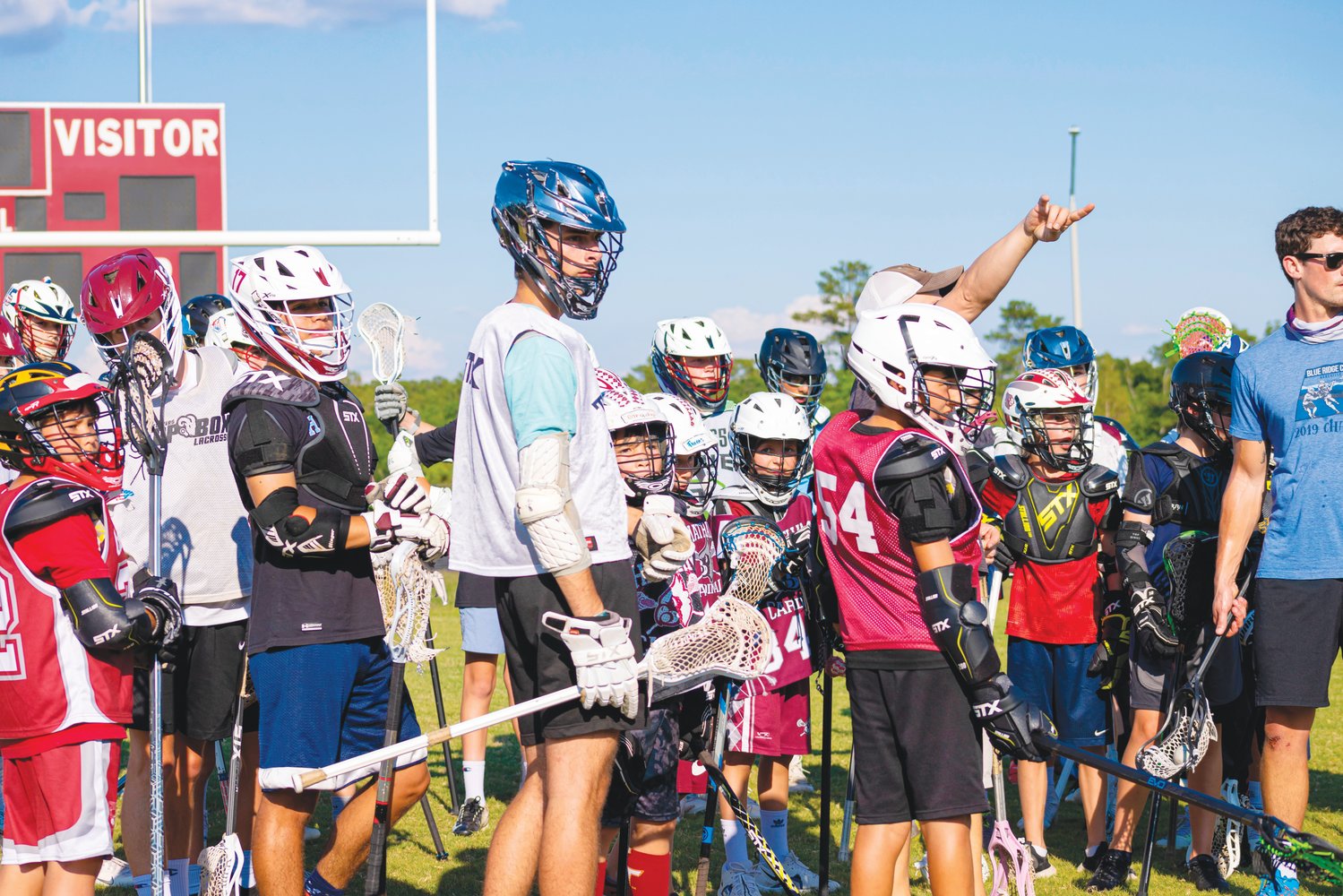 A group of campers, including Payne Swenson (center), await instructions during Seaforth's youth lacrosse camp last Thursday.
