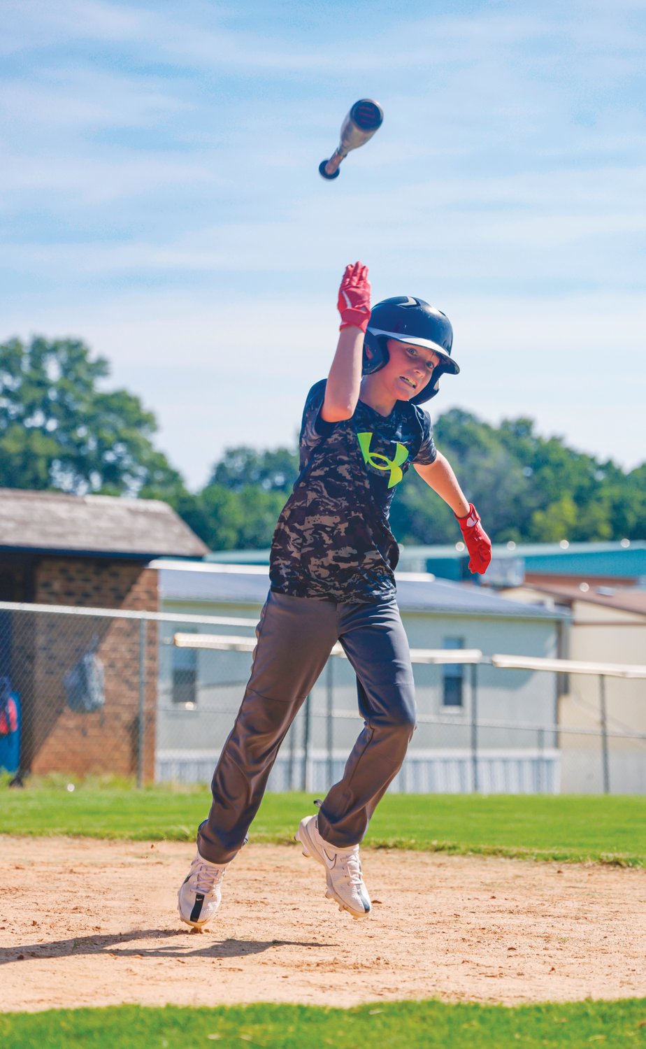 Hayden, a camper at Jordan-Matthews' annual baseball camp, flips his bat after a hit during the camp's final day last Thursday.