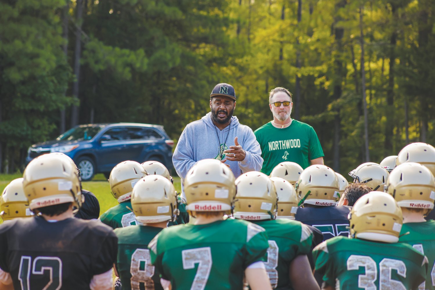 Northwood football head coach Chris Kenan addresses his team during the first week of high school football practice across Chatham County.