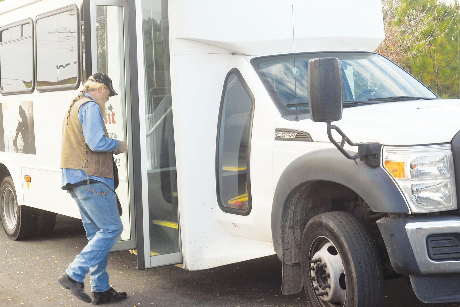 Robert Gullie boards a Chatham Transit bus at Lowe’s Home Improvement in Pittsboro. Gullie, a construction worker, uses the service to get to work daily.