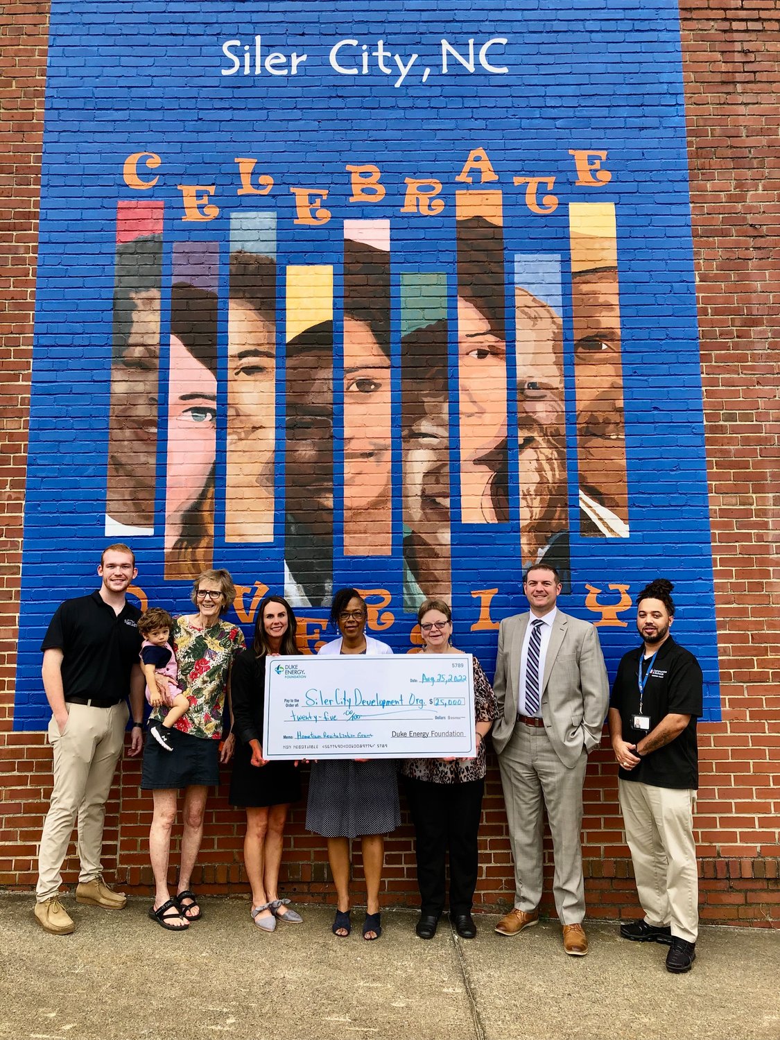 Officials from the Siler City Development Organization receive a $25,000 Duke Energy Hometown Revitalization grant to help improve building facades and interior rehabilitation downtown.